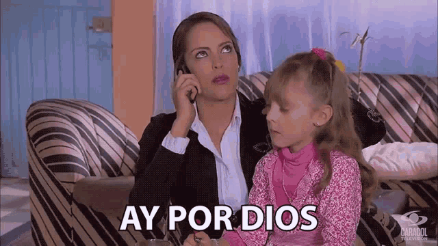 a woman talking on a cell phone next to a little girl with ay por dios written on the screen