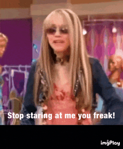 a woman wearing sunglasses and a denim jacket says stop staring at me you freak