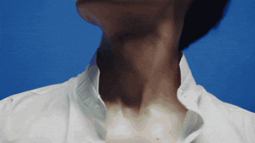 a close up of a person 's neck and collar with a blue background