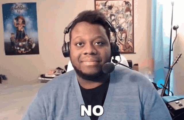 a man wearing headphones and a microphone has the word no on his chest