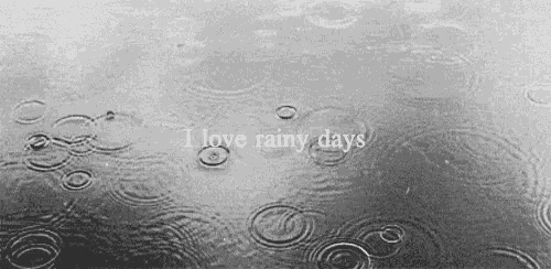 a black and white photo of rain drops in a puddle with the words `` i love rainy days '' written on it .