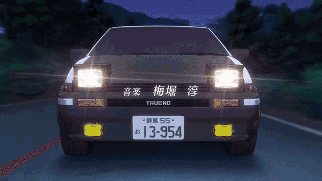 a black and white truend car is driving down a road