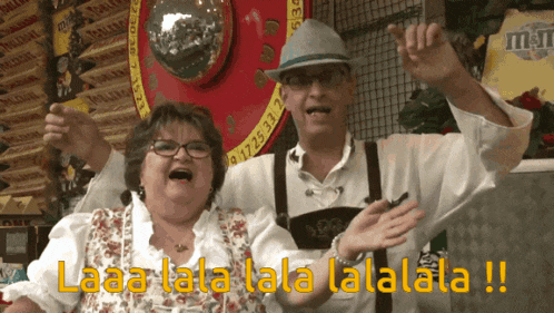 a man and a woman are standing next to each other with the words laaa lala lala lalala written on the screen