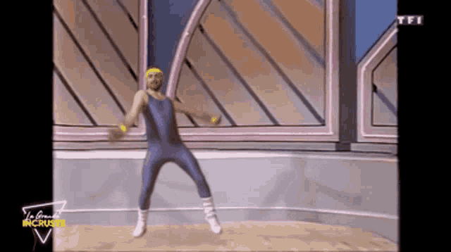 a man is dancing in front of a sign that says tfi on it