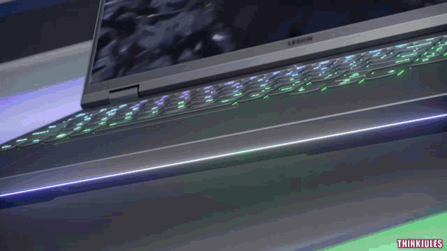 a lenovo laptop with a green light on the bottom