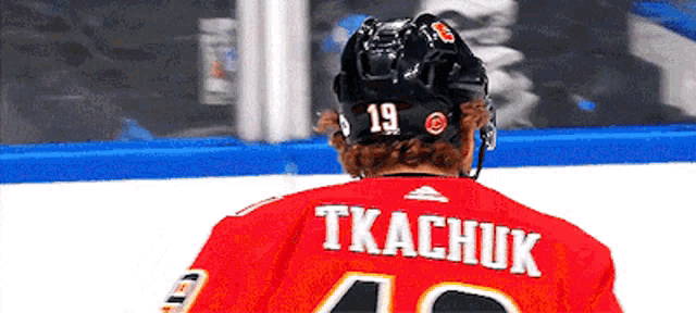 a hockey player named tkachuk wears a red jersey
