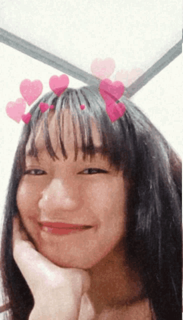 a young girl with hearts in her hair is smiling