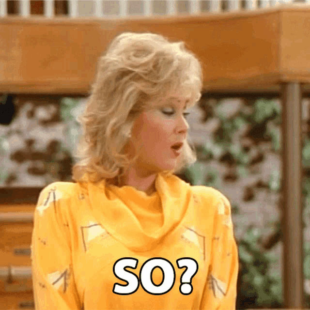 a woman in a yellow sweater has the word so on her chest