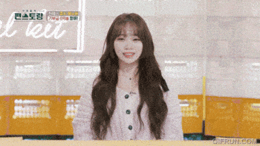 a girl is smiling in front of a sign that says ' gifrun.com ' on it