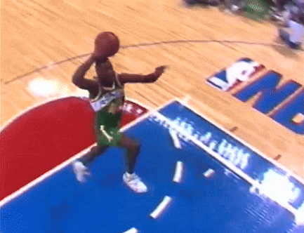 a basketball player is jumping in the air to catch a basketball