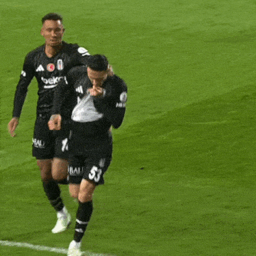 a soccer player with the number 53 on his shorts is running on the field