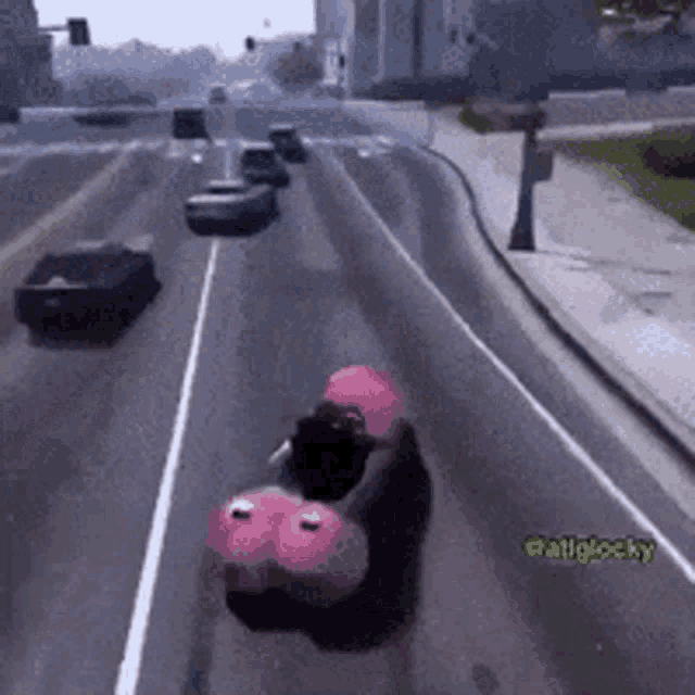 a video game character is driving down a road with a pink balloon on the back .