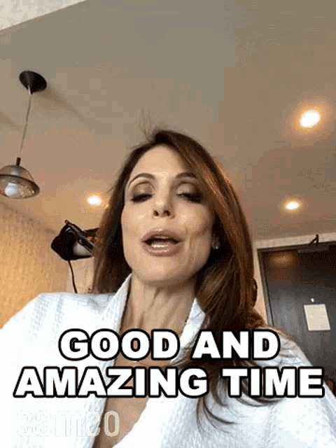 a woman in a bathrobe is saying good and amazing time