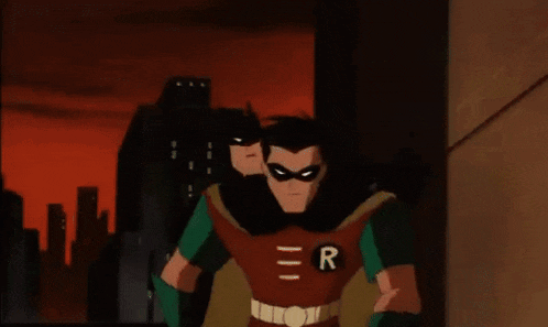 robin is carrying batman in his arms and the letter r is on his chest