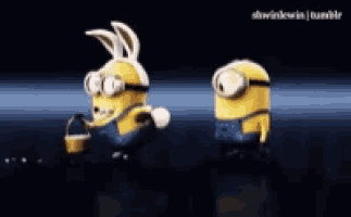 two minions are standing next to each other with one wearing a bunny hat
