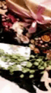 a painting of flowers with a pink ribbon on it