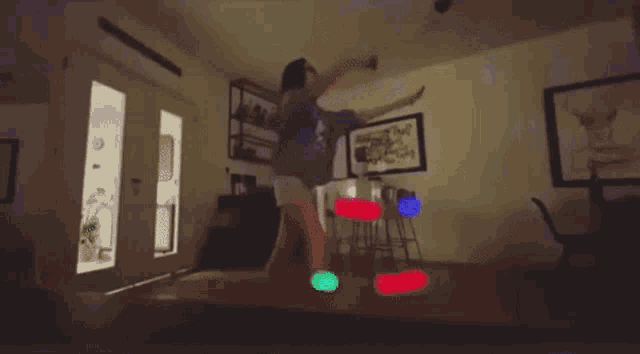 a person is dancing in a room with a picture on the wall