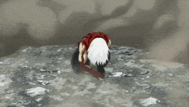 a person with white hair is kneeling down on a rocky surface