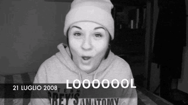 a black and white photo of a woman wearing a beanie and a grey 's anatomy hoodie