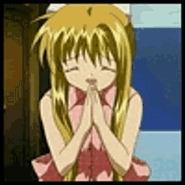 a girl in a pink dress is praying with her hands together .