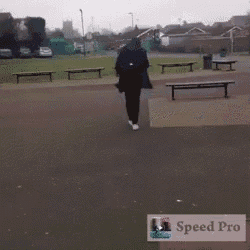 a man is walking in a park with a speed pro logo behind him