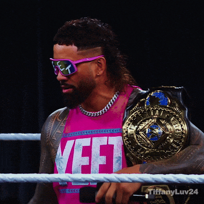 a man wearing sunglasses and a pink shirt with the word yefi on it