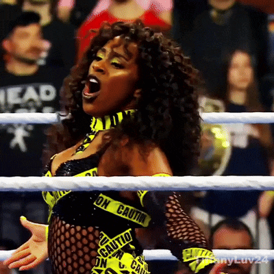 a woman in a wrestling ring with a caution tape around her neck