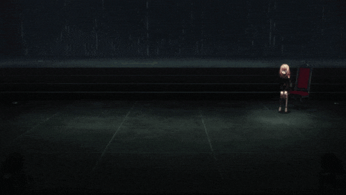 a person kneeling on the floor in a dark room