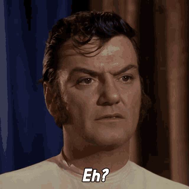 a man in a white shirt says " eh " on his face