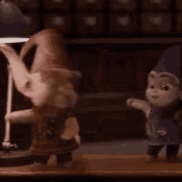 two gnomes are standing next to each other on a wooden table