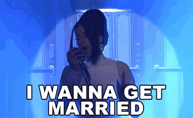 a woman singing into a microphone with the words " i wanna get married " below her