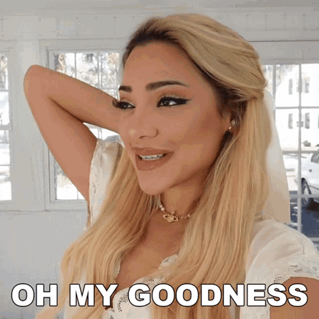 a woman with blonde hair is smiling with the words oh my goodness below her