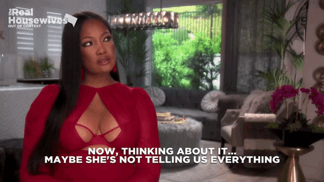 a woman in a red dress says " now thinking about it "