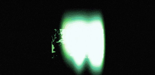 a blurry picture of a green sphere with a black background