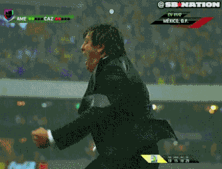 a man in a suit and tie holds his hands to his head while watching a soccer game on sb nation