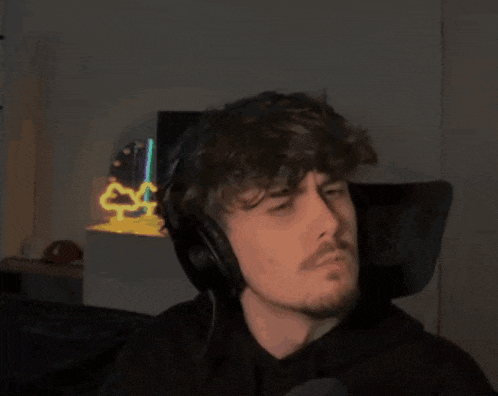 a man wearing headphones has a tattoo on his hand