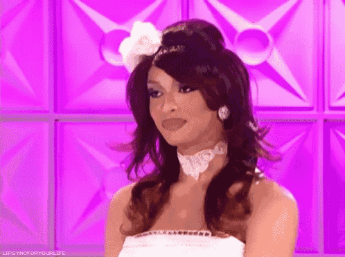 a woman in a white dress is making a funny face .
