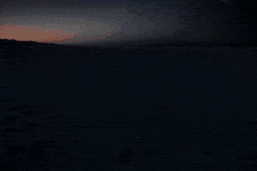 a plain with mountains in the distance and a blue sky in the background