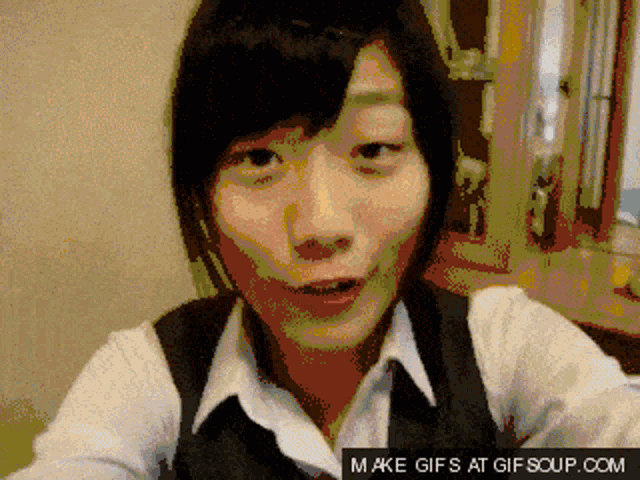a pixelated image of a woman with the words make gifs at gifsoup.com below it