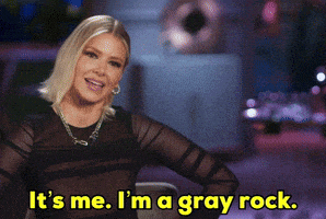 a woman in a black top is saying it 's me i 'm a gray rock