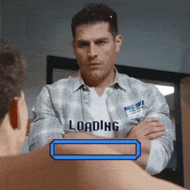a man with a name tag that says visito on it stands in front of a loading bar