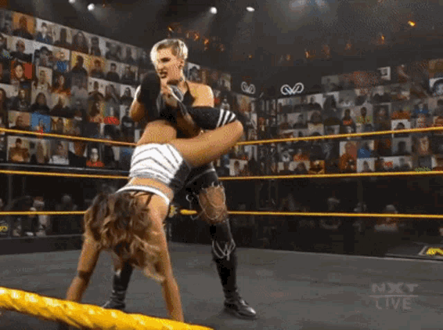two women are wrestling in a ring with the words next live on the bottom