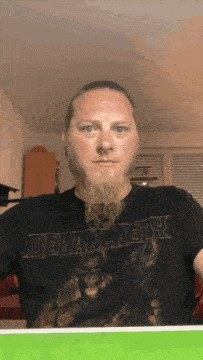 a man with a beard is wearing a black shirt that says debauchefly