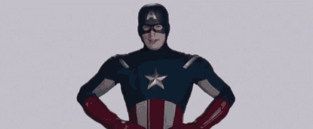 a man in a captain america costume is standing with his hands on his hips and the word patience written on the bottom .