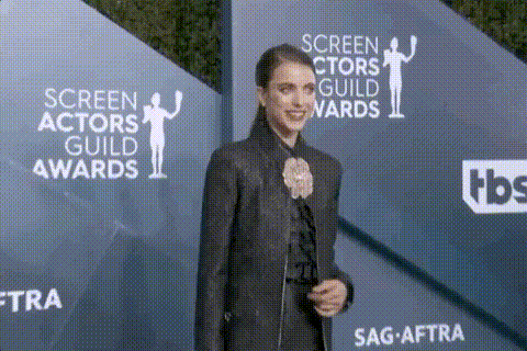 a woman is standing in front of a wall that says screen actors guild awards on it .