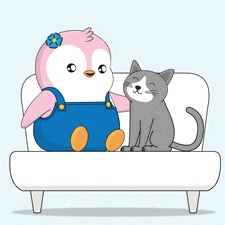 a penguin and a cat are sitting on a white couch