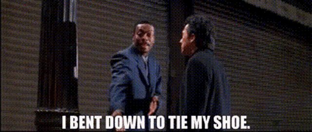 a man in a suit and tie is talking to another man in a suit and tie .