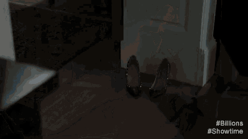 a woman in a blue dress is standing in a dark room .