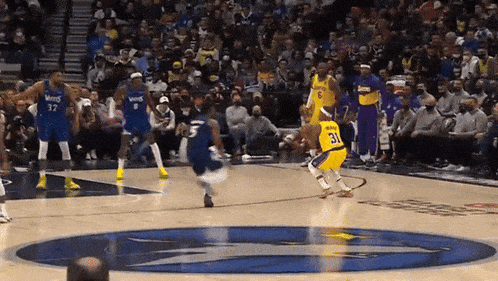 a basketball player wearing a number 31 jersey dribbles the ball