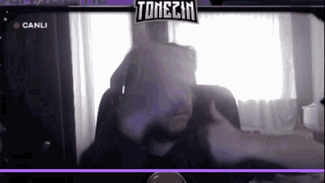 a man giving a thumbs up in front of a screen that says tonezin